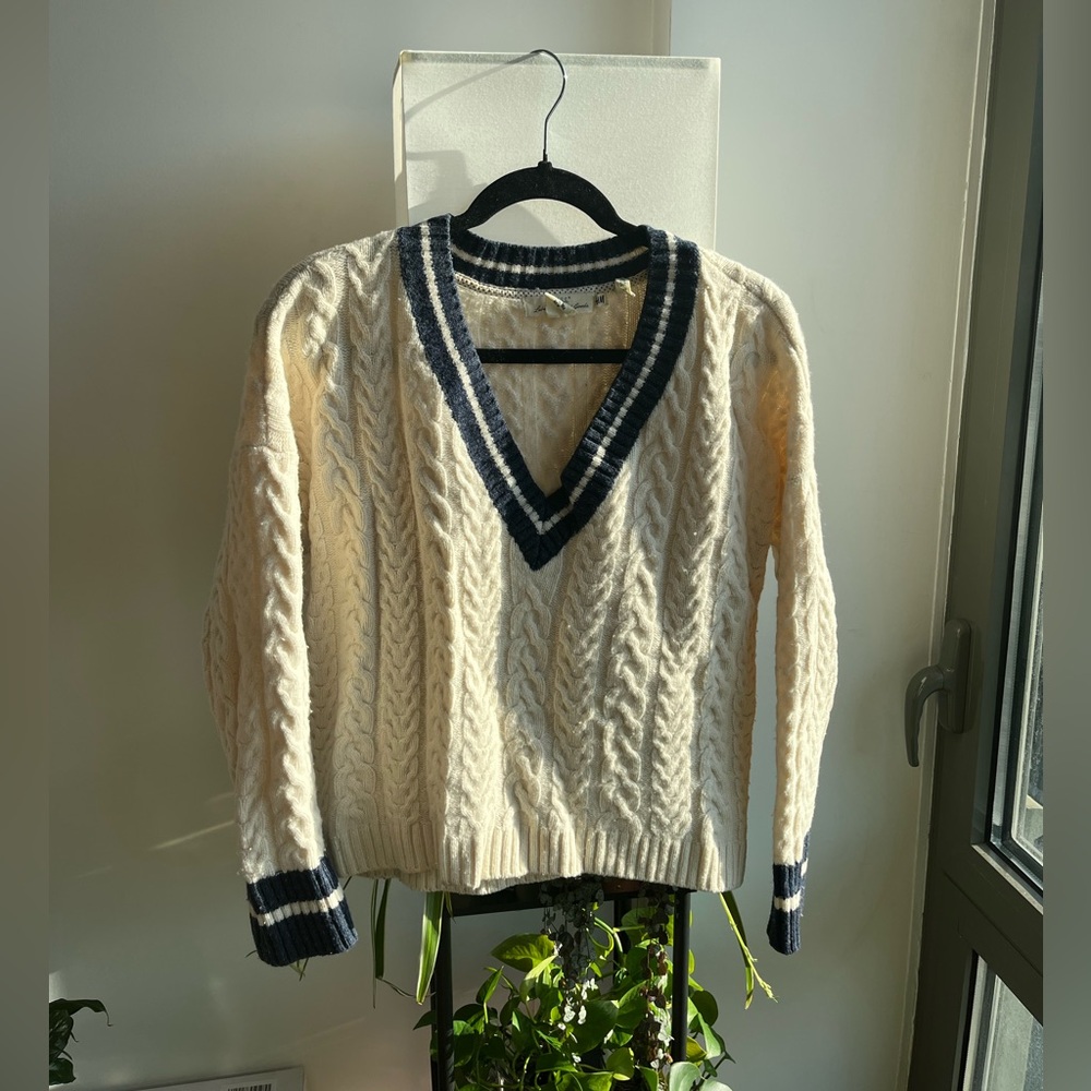 Cream cricket sweater with navy blue accents